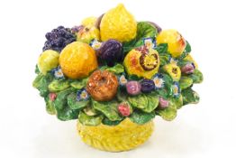 An Italian majolica bowl centrepiece, the lift off lid in the form of a bouquet of fruit,