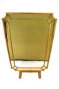 A rectangular wall mirror with convex cantered corners,