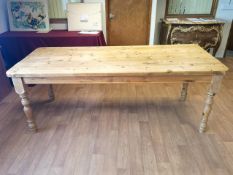 A pine rectangular dining table with plank form top on as plain frieze and four fancy baluster