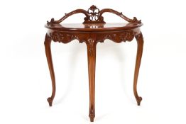 A mahogany demi lune side table with carved scroll back and frieze on cabriole legs,
