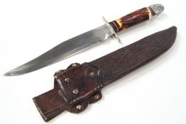 An Indian head Bowie knife, in a leather sheath,