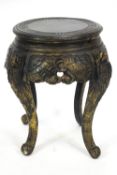 A Chinese style carved wood jardiniere stand, painted black, on four scroll legs,