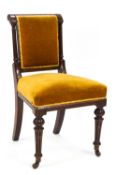 A Victorian mahogany framed chair on turned tapering fluted legs with ceramic casters