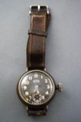 An army service wristwatch by Ingersoll Radiolite. Gilt case with brown leather strap.