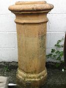 A 19th century terracotta chimney pot, of octagonal form with a protruding collar top,