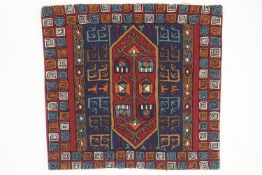 An Iraqi Marsh Arab woolwork blanket/hanging embroidered with bands of alternating lozenges