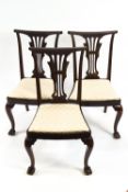 A set of six mahogany dining chairs with pierced splats and drop in seats,