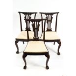 A set of six mahogany dining chairs with pierced splats and drop in seats,