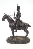 A bronze statue of a Cavalryman on a horse standing on marble base,