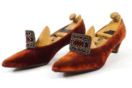 A pair of ladies red velvet shoes with cut steel buckles and leather soles and another pair