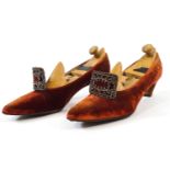 A pair of ladies red velvet shoes with cut steel buckles and leather soles and another pair