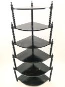 An ebonised Victorian style six tier waterfall what not with barley twist supports,