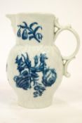 An 18th century Worcester cabbage leaf jug with moulded mask spout painted in blue