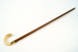 A Victorian malacca walking cane with embossed gilt metal handle,