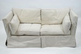 A yellow upholstered two seat Knole style sofa,