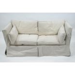 A yellow upholstered two seat Knole style sofa,