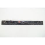 A 19th century mixed wood wall mounted Bridle rack for six bridles, over painted in black,