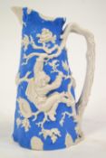 A Davenport Parian jug relief moulded in blue on white with boys stealing bird's nests