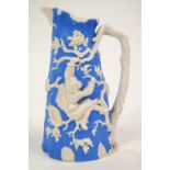 A Davenport Parian jug relief moulded in blue on white with boys stealing bird's nests