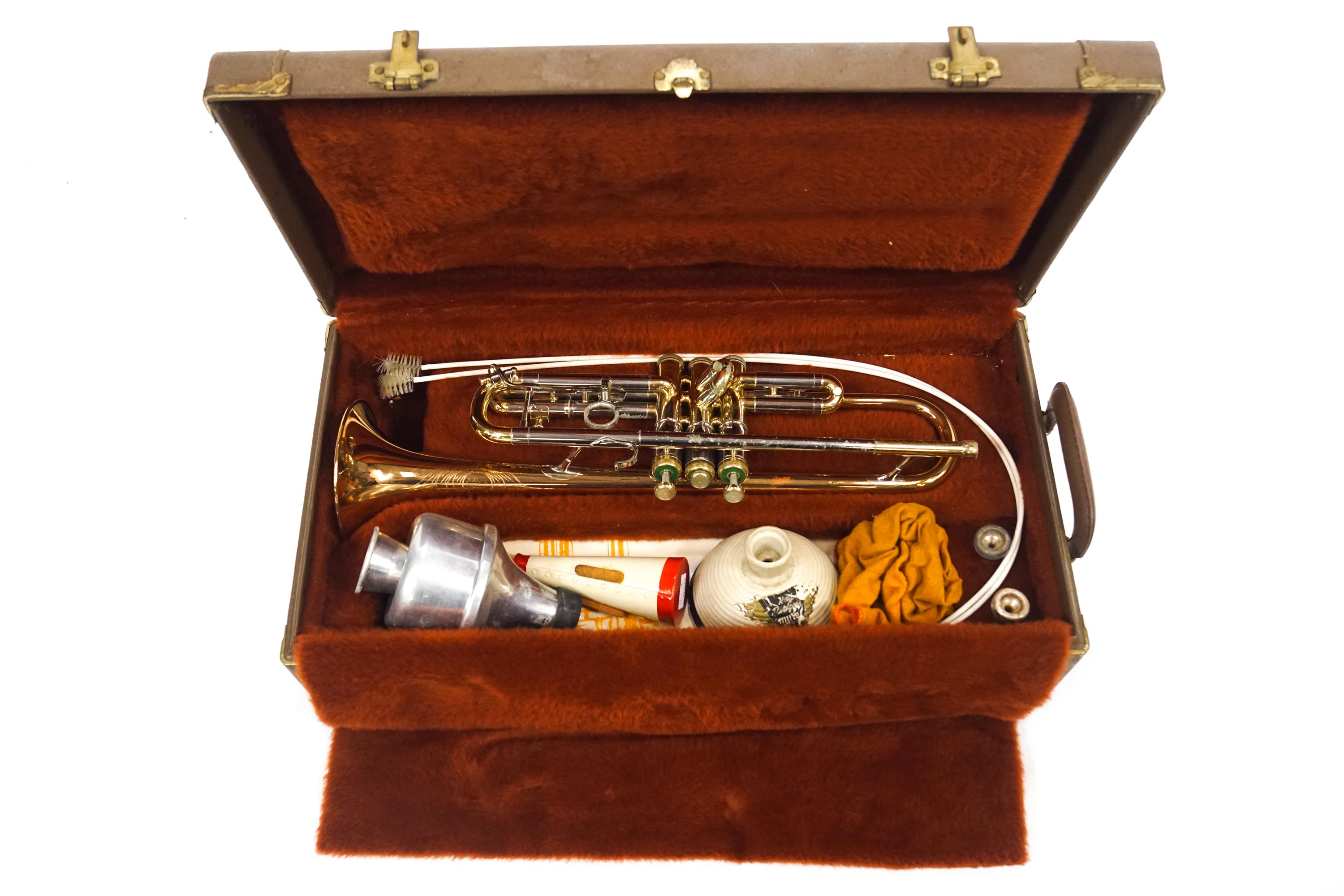 An Olds trumpet, in original case, with three mutes,