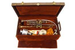 An Olds trumpet, in original case, with three mutes,