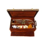 An Olds trumpet, in original case, with three mutes,