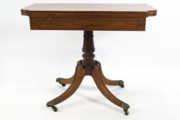 A 19th century mahogany tea table with turned pedestal issuing four splayed legs,