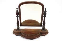 A Victorian mahogany swing frame dressing table mirror, the shaped base with hinged cover,