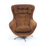 A mid century swivel chair, with button back and seat in pressed brown velvet style fabric,