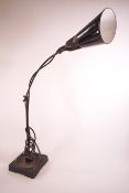 An adjustable desk lamp by Waligraph, with black and white enamel shade,