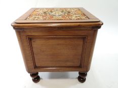 A 19th century mahogany commode of squared form, raised on turned baluster legs,