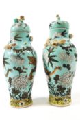 A pair of 20th century Japanese vases, of baluster form with lift off lids,