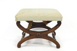 A Regency rosewood and upholstered rectangular stool, the shaped legs linked by turned stretchers,