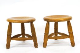 A pair of three legged milking stools, one stamped Chapel House Furniture,