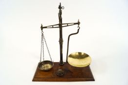 A 19th century set of brass scales on mahogany plinth base,