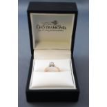 A yellow and white metal single stone diamond ring,