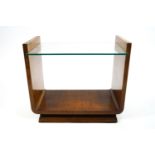 A 1930's Art Deco style occasional table, the mahogany frame supporting a glass top,