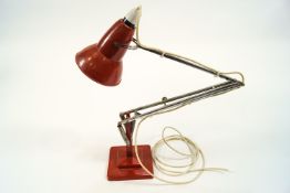 An anglepoise light by Herbert Terry, in rust red,