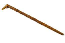 An Africa walking stick, all over carved with elephant head handle,