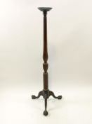 A mahogany torchere, the cabriole legs with ball and claw feet,