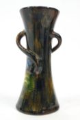 A Torquay terracotta waisted three handled vase with floral marbled style decoration,