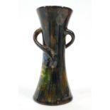 A Torquay terracotta waisted three handled vase with floral marbled style decoration,