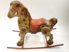 A 1950's tin rocking horse,