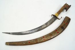 A Moroccan Flyssa, the scabbard and grip inlaid with wire work,