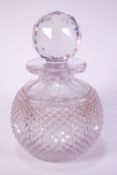 A cut glass scent bottle with faceted stopper,