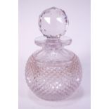 A cut glass scent bottle with faceted stopper,