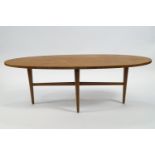 An oval coffee table, designed by Gordon Russell, on turned tapering legs,