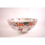 An 18th century Chinese porcelian bowl, decorated with scholars amongst foliage,