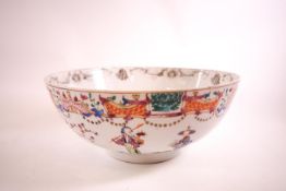 An 18th century Chinese porcelian bowl, decorated with scholars amongst foliage,