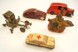 Two tin plate cars, together with a tin plate clown on a bear,